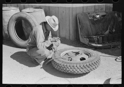 Changing tire at the garage. Pie Town, New Mexico