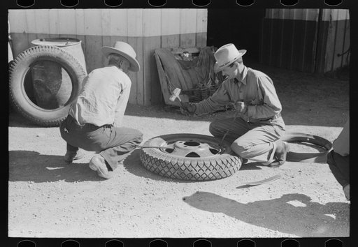 Changing tire at the garage. Pie Town, New Mexico