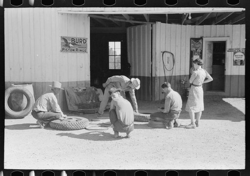 Untitled photo, possibly related to: Changing tire at the garage. Pie Town, New Mexico