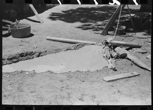 Untitled photo, possibly related to: Woman guiding the drilling tool for water well drilling. Pie Town, New Mexico
