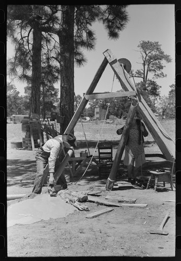 Farmer emptying slush from well which he is drilling with cable tools. Pie Town, New Mexico