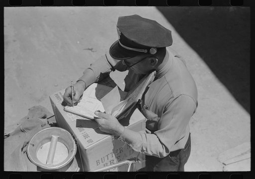 Untitled photo, possibly related to: Stage driver making out express receipt. Pie Town, New Mexico