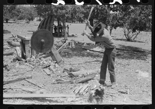 Farmer chopping wood. Pie Town, New Mexico