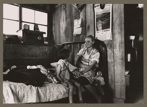 Mrs. Caudill and her daughter in their dugout, Pie Town, New Mexico. The Caudills have one of the few radios in their neighborhood, and many farmers and their families visit the Caudills on winter nights to listen to music and news and play Forty Two