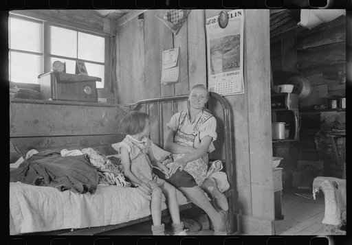 Untitled photo, possibly related to: Mrs. Caudill and her daughter in their dugout, Pie Town, New Mexico. The Caudills have one of the few radios in their neighborhood, and many farmers and their families visit the Caudills on winter nights to listen to music and news and play Forty Two