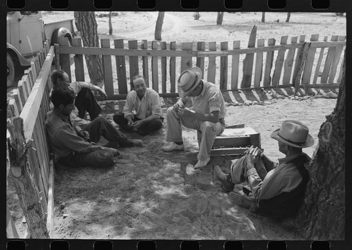 Homesteaders sit under the trees at all day Sunday visiting. Pie Town, New Mexico