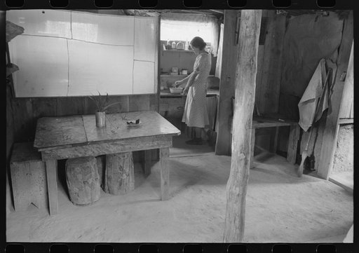 Woman in adobe house, Pie Town, New Mexico