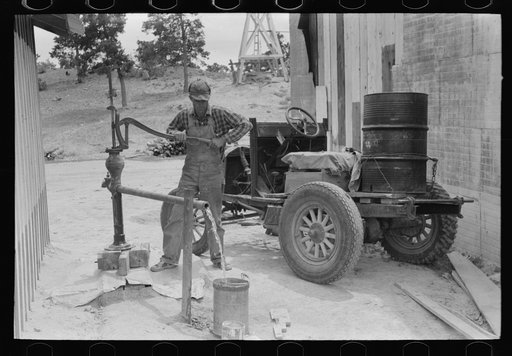 Homesteader pumping water which he will haul home from town. Wells require cash to drill and some farmers have not yet been able to drill their own wells. Pie Town, New Mexico