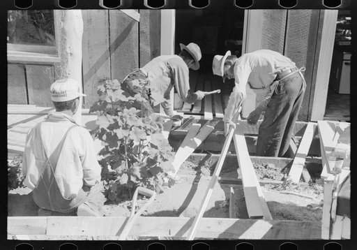 Farmers building porch to Mr. Craig's new house. Mr. Craig pays wages for all work which is done for him. Pie Town, New Mexico