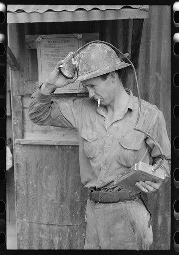Gold mine removing light from his metal hat, Mogollon, New Mexico