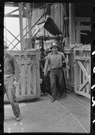 Miners coming out of cage which hoists them from working level. Mogollon, New Mexico