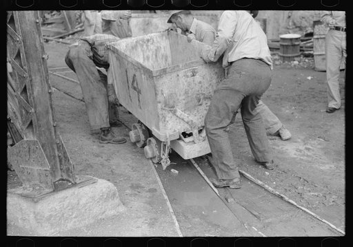 Untitled photo, possibly related to: Moving ore car on narrow gage railroad track at gold mine, Mogollon, New Mexico