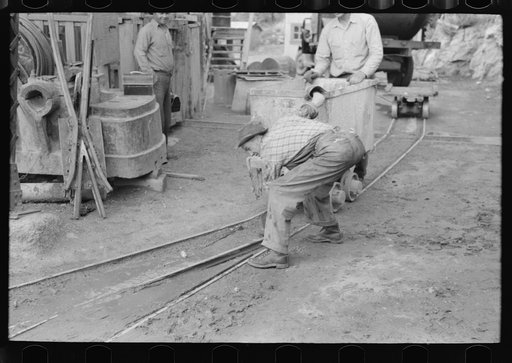 Untitled photo, possibly related to: Moving ore car on narrow gage railroad track at gold mine, Mogollon, New Mexico