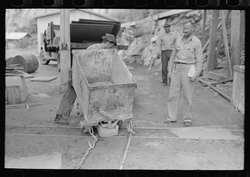 Moving ore car on narrow gage railroad track at gold mine, Mogollon, New Mexico