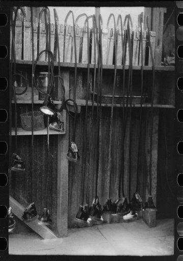 Untitled photo, possibly related to: A row of miners' safety lamps and batteries in caretaker's office. Gold mine at Mogollon, New Mexico