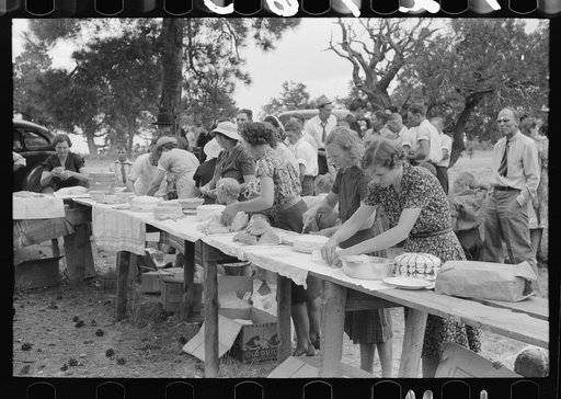 Putting food on the tables for dinner at the all day community sing. Pie Town, New Mexico