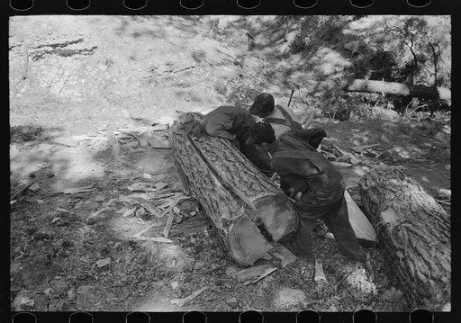 Untitled photo, possibly related to: Driving in wooden wedge to split logs which will then be cut with broadaxe into ties, Pie Town, New Mexico