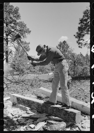 Chipping off the slab before log is finished with broadaxe into a tie. Pie Town, New Mexico