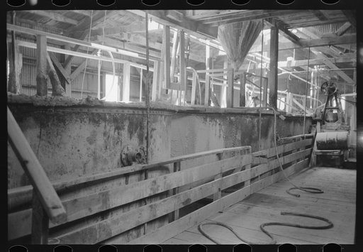 Large tanks used for mixing powdered gold ore with cyanide solution to extract gold and silver, gold mine, Mogollon, New Mexico
