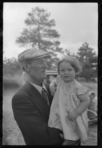 Untitled photo, possibly related to: Mr. Bill Stagg putting container of food which was left from dinner at the community sing back into the car. Pie Town, New Mexico