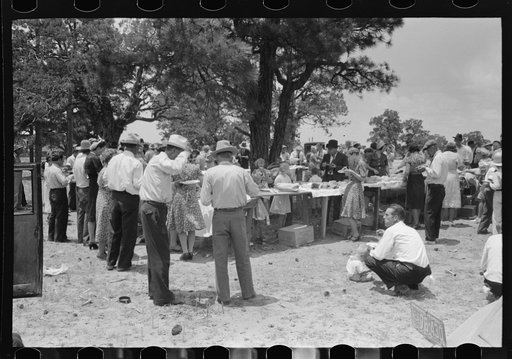 Dinner on the grounds at all day community sing, Pie Town, New Mexico. The tables are left in place permanently and are used frequently by the entire community for picnics and dinners