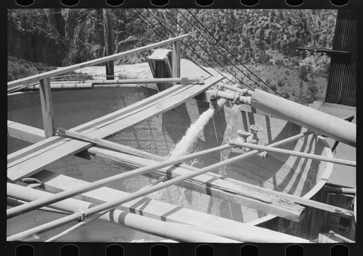 Water being discharged into large mixing vats. Mill at gold mine, Mogollon, New Mexico