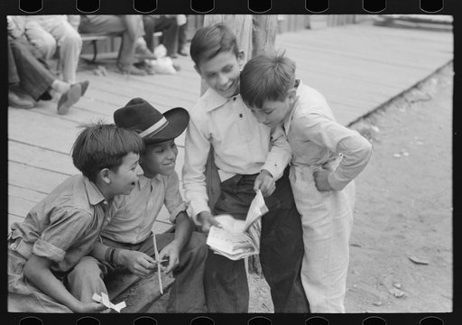 Untitled photo, possibly related to: Children of gold miners looking at the comics, Mogollon, New Mexico