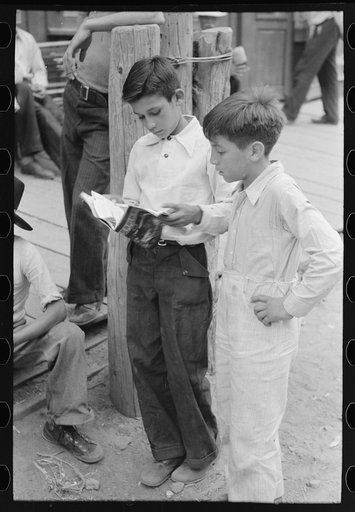 Children of gold miners looking at the comics, Mogollon, New Mexico