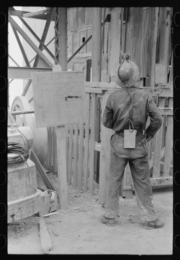 Gold miner waiting for cage to be lowered underground, Mogollon, New Mexico