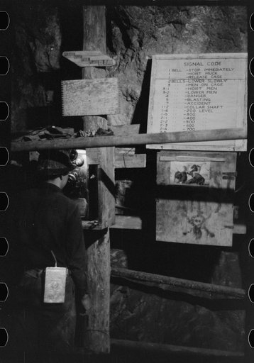 Miner using telephone at 500-foot level at gold mine. Mogollon, New Mexico