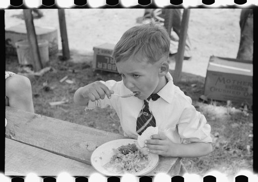 Youngster eating dinner at all day community sing, Pie Town, New Mexico