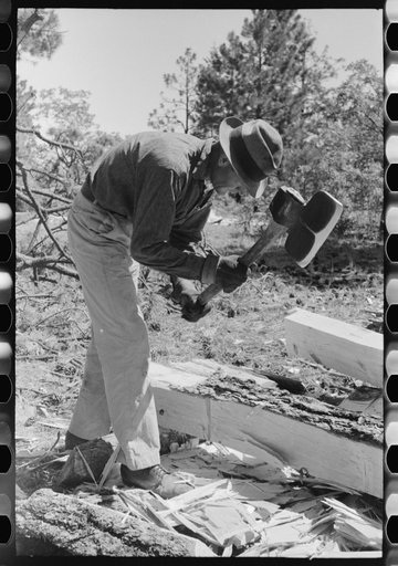 Using a broad axe in hewing ties, Pie Town, New Mexico