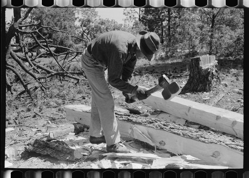 Using a broad axe in hewing ties, Pie Town, New Mexico