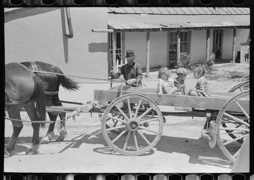 Spanish-American farmer and family arriving at Penasco, New Mexico for shopping