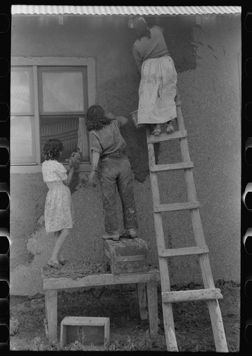 Untitled photo, possibly related to: General view of plastering adobe house, Chamisal, New Mexico