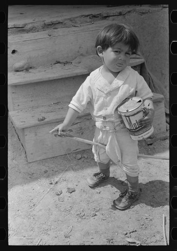 Spanish-American boy playing horse, Chamisal, New Mexico