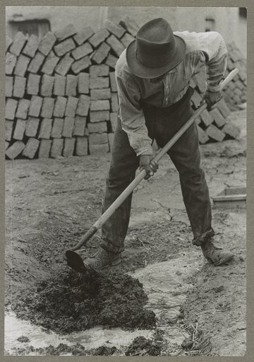 Dirt, straw and water are mixed to form the adobe mixture for bricks, Chamisal, New Mexico