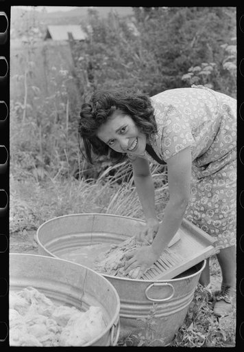 Spanish-American girl washing wool, Chamisal, New Mexico