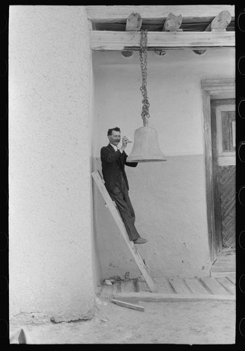 Spanish-American ringing bell with rock at the Church of the Twelve Apostles, Trampas, New Mexico. Church is 350 years old