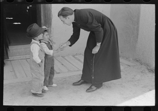 Untitled photo, possibly related to: Catholic priest greeting small Spanish-American boy after Mass. Trampas, New Mexico