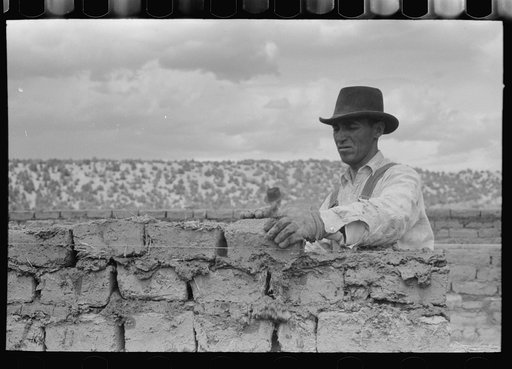 Spanish-American workman laying adobe bricks, Penasco, New Mexico
