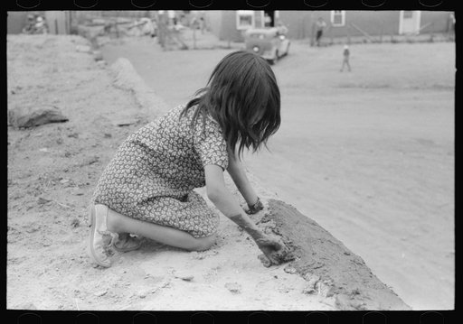 Untitled photo, possibly related to: Spanish-American girl plastering edge of roof of adobe house. Costilla, New Mexico