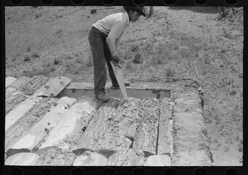 Detail of corner of roof of adobe house before mud is spread on. Amalia, New Mexico