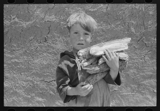 Untitled photo, possibly related to: Spanish-American boy with an armful of wood. Chamisal, New Mexico