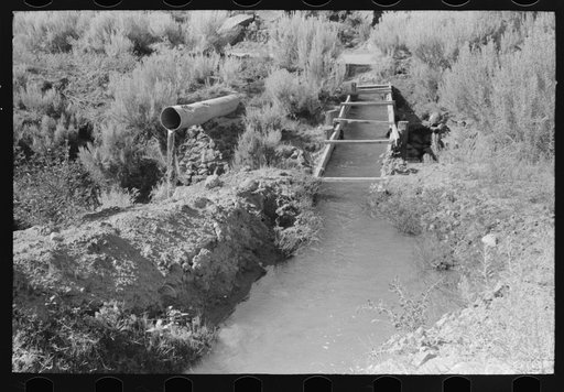 Irrigation ditch carried across an arroyo. Taos County, near Dixon, New Mexico