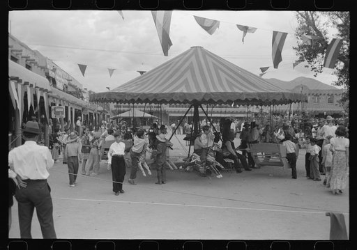 Old merry-go-round at Taos, New Mexico, during fiesta. This is reputed to be the oldest merry-go-round in America