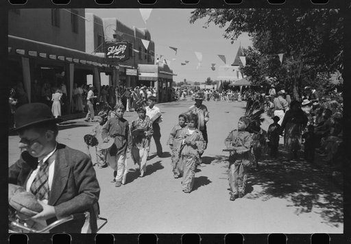 Untitled photo, possibly related to: Crowds lined the streets and stood on top of covered sidewalks to see the dances at the fiesta, Taos, New Mexico