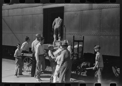 Taking the newspapers off the morning train, Montrose, Colorado