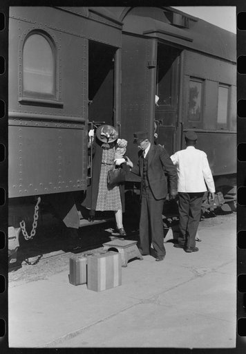 Passenger, alighting from morning train, Montrose, Colorado
