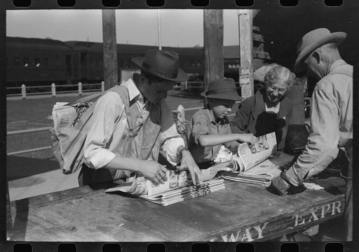 Newsboys getting the papers just after the arrival of the morning train, Montrose, Colorado. While there is a daily paper in this town here as in most towns of this size, the papers from the larger cities are popular